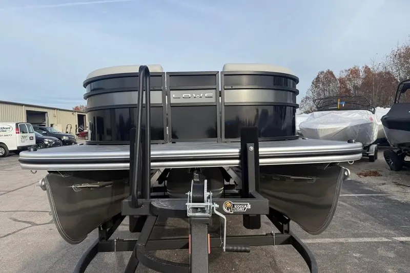 Slide: The Image of 2026 Lowe SS 230 WV pontoon boat on trailer, parked outdoors. - 2