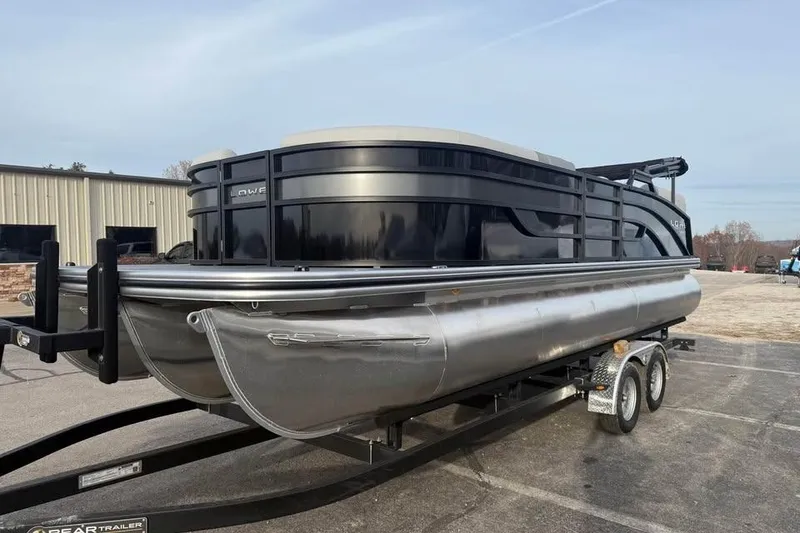 Slide: The Image of 2026 Lowe SS 230 WV pontoon boat on trailer, parked outdoors. - 3