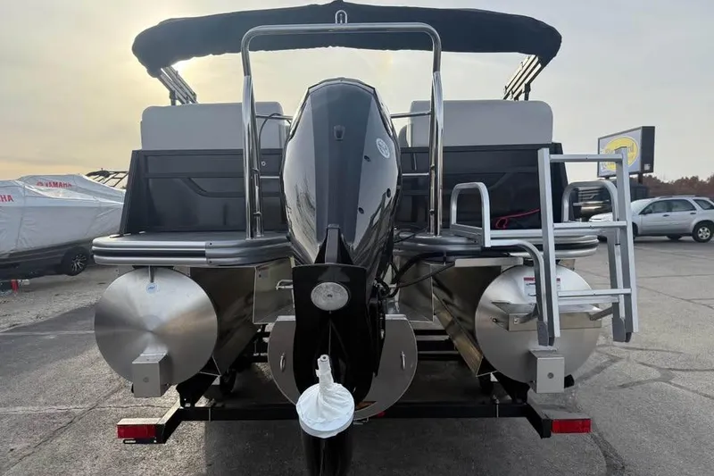 Slide: The Image of 2026 Lowe SS 230 WV pontoon boat with outboard motor, parked on a trailer. - 6