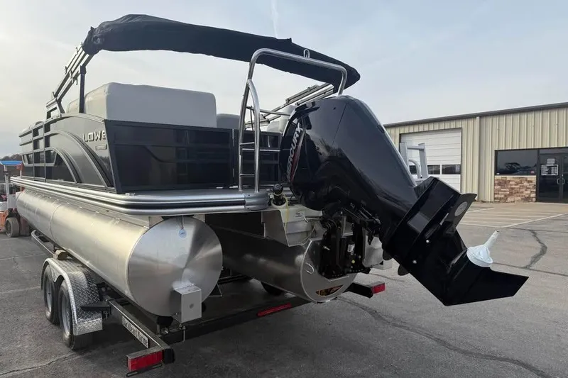 Slide: The Image of 2026 Lowe SS 230 WV pontoon boat on trailer, featuring a powerful outboard motor. - 7