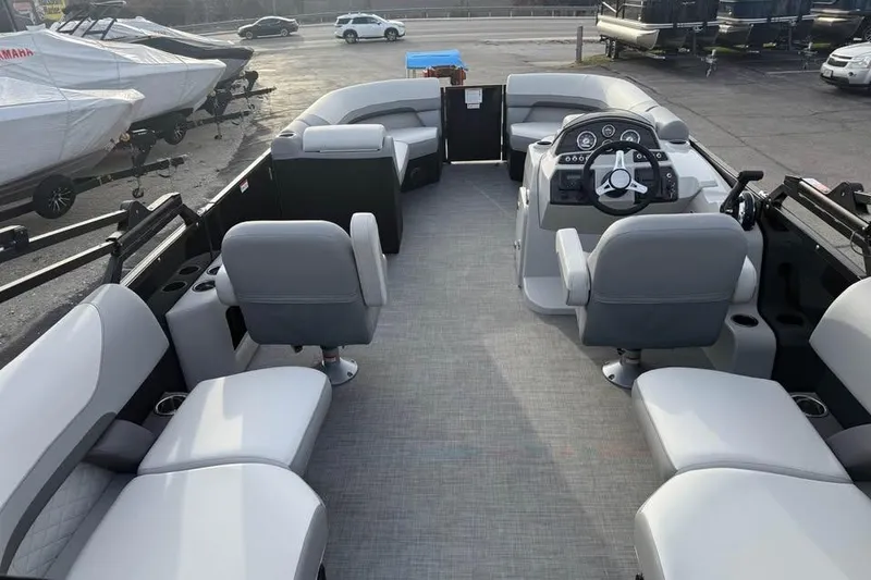 Slide: The Image of 2026 Lowe SS 230 WV pontoon boat interior with gray seating and steering console. - 9
