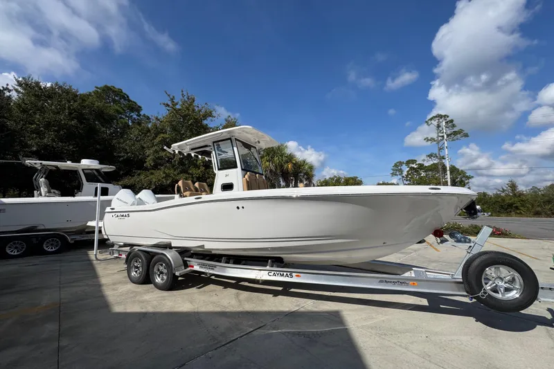Slide: The Image of 2026 Caymas 291 boat on trailer under clear blue sky. - 10