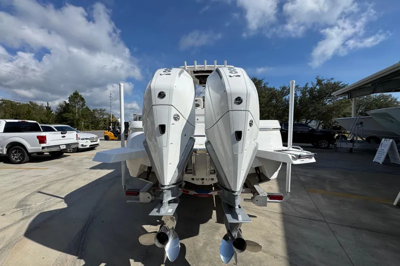 Slide: The Image of 2026 Caymas 291 boat with dual outboard engines in a sunny outdoor setting. - 15