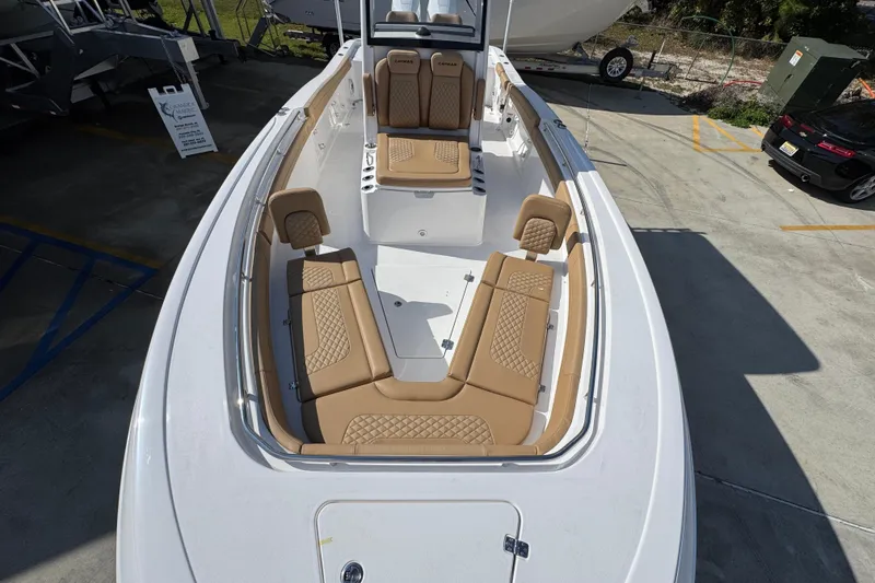 Slide: The Image of 2026 Caymas 291 boat with tan seating, docked in a marina. - 22