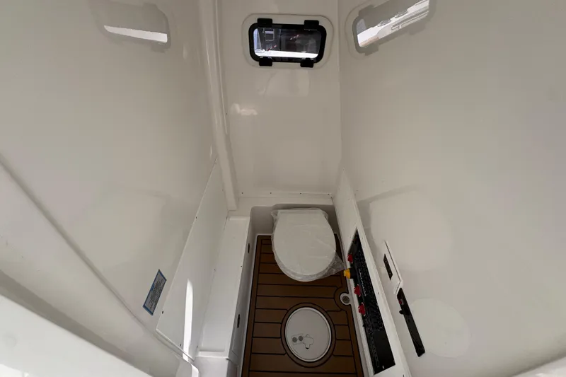 Slide: The Image of Interior of 2026 Caymas 291 boat bathroom with modern fixtures and wood-style flooring. - 27