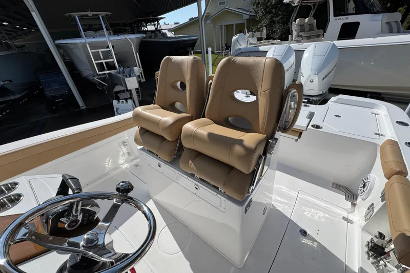 Slide: The Image of 2026 Caymas 291 boat interior with tan seats and steering wheel. - 28