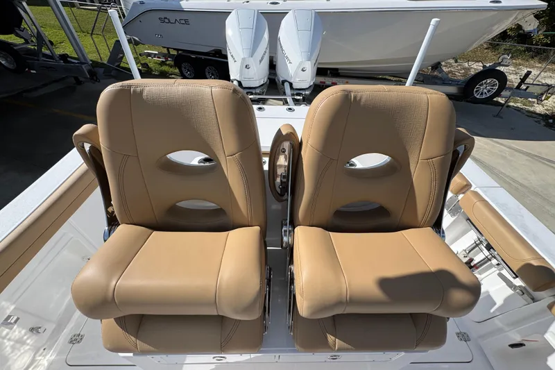 Slide: The Image of Luxury seating on 2026 Caymas 291 boat, featuring tan leather chairs and modern design. - 29