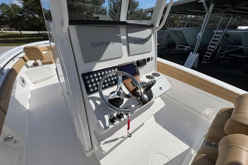 Slide: The Image of 2026 Caymas 291 boat cockpit with Garmin navigation system and modern steering controls. - 31