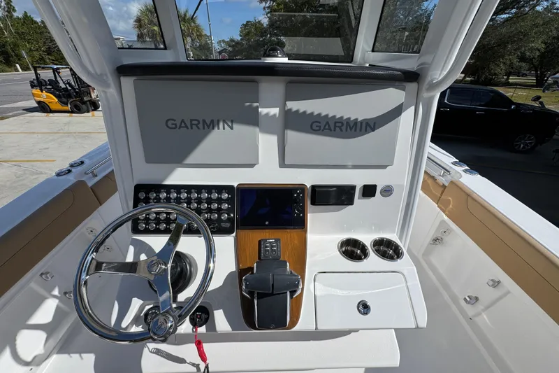 Slide: The Image of 2026 Caymas 291 boat dashboard with Garmin displays and steering wheel. - 32