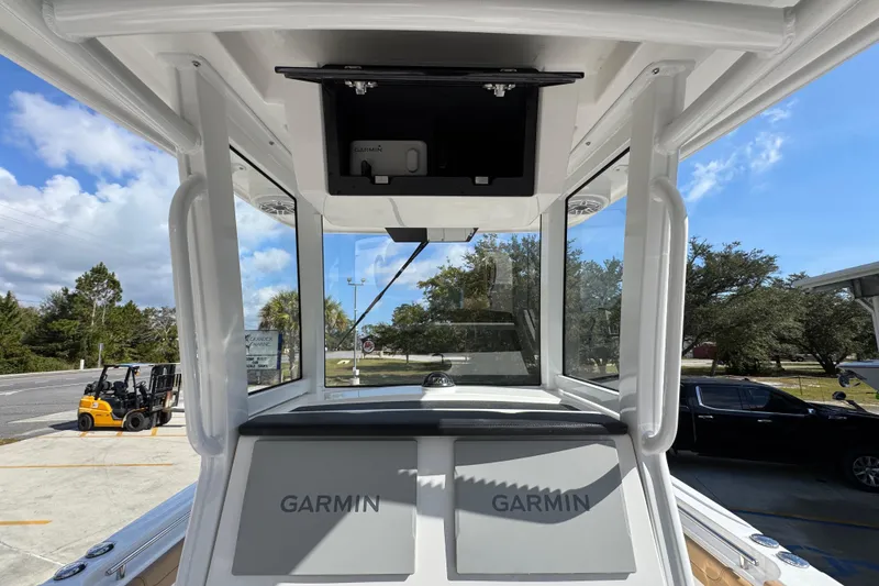 Slide: The Image of 2026 Caymas 291 boat cockpit with Garmin navigation system, clear skies, and outdoor setting. - 33