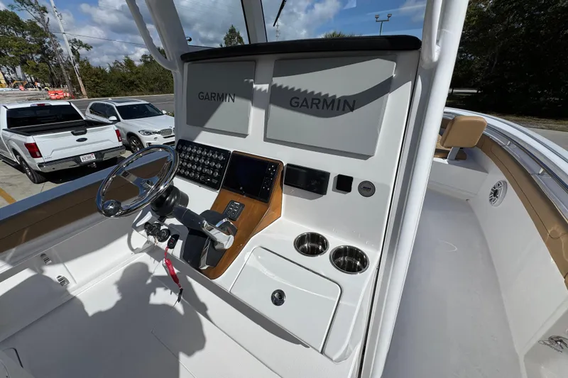 Slide: The Image of 2026 Caymas 291 boat cockpit with Garmin navigation system and modern controls. - 34