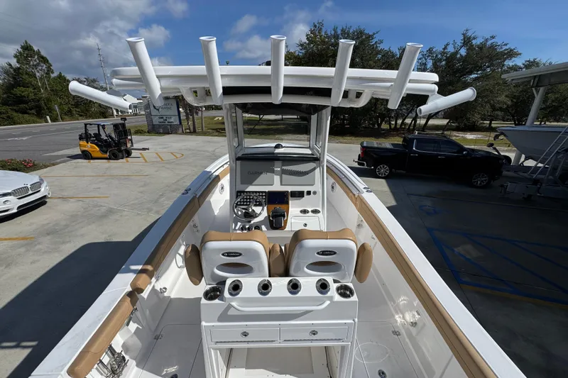 Slide: The Image of 2026 Caymas 291 boat interior with helm, rod holders, and seating. - 38