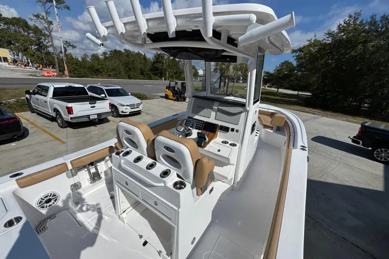 Slide: The Image of 2026 Caymas 291 boat interior with modern helm, parked vehicles in background. - 39