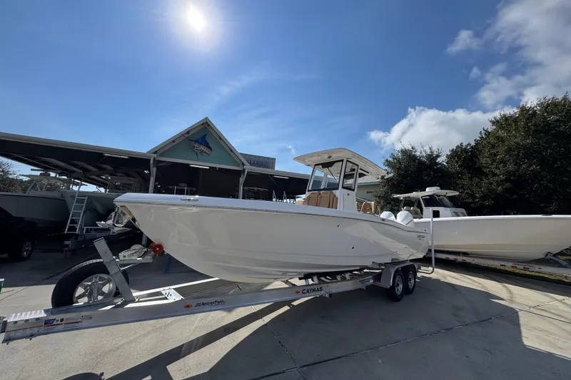 Slide: The Image of 2026 Caymas 291 boat on trailer under sunny sky at marina. - 4