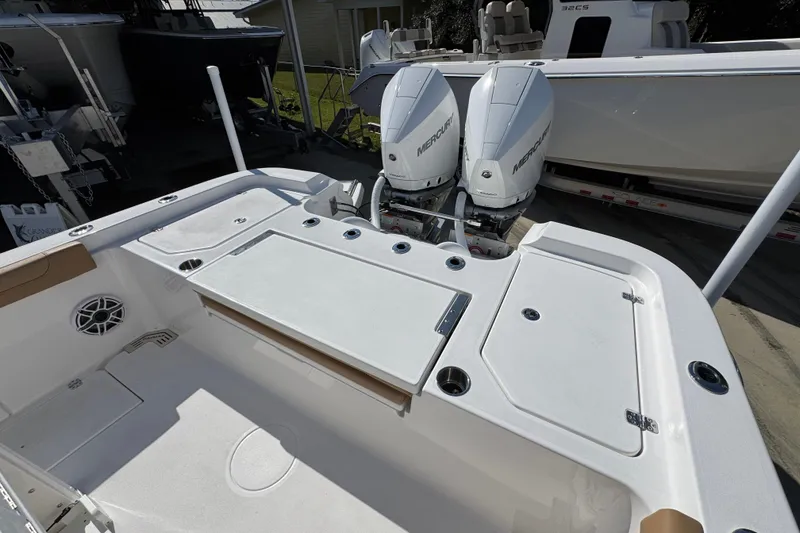 Slide: The Image of 2026 Caymas 291 boat with dual Mercury engines, spacious deck, and modern design. - 41