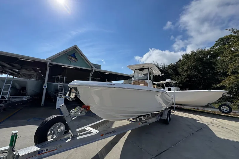 Slide: The Image of 2026 Caymas 291 boat on trailer under sunny sky near marina. - 5