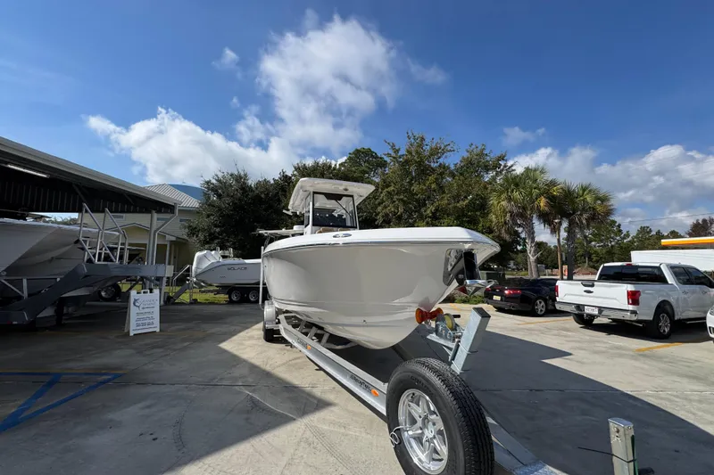 Slide: The Image of 2026 Caymas 291 boat on trailer in sunny outdoor setting. - 8