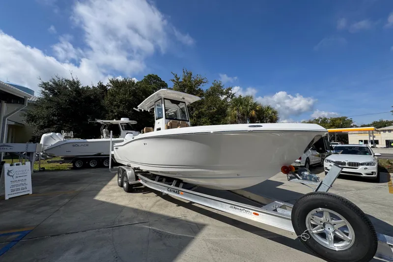 Slide: The Image of 2026 Caymas 291 boat on trailer under clear blue sky. - 9