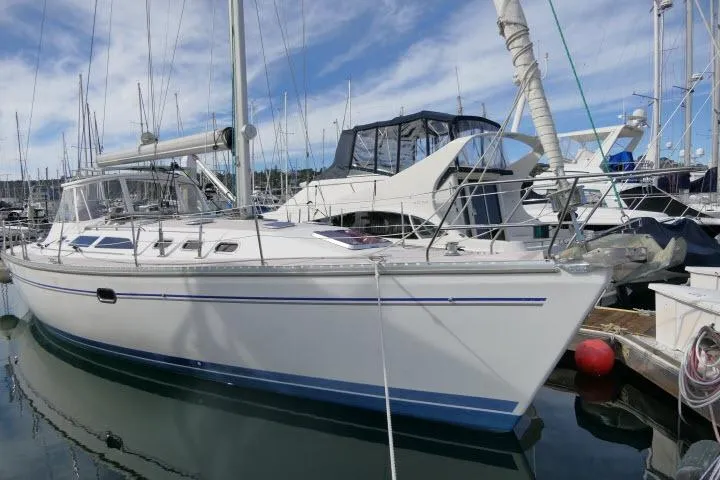 The Image of 2008 Catalina 400 MK II sailboat docked in a marina under a clear blue sky. - 1