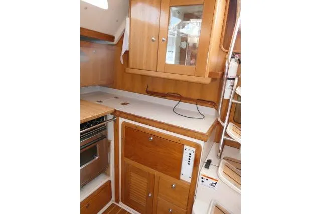 Slide: The Image of 2008 Catalina 400 MK II yacht interior kitchen with wooden cabinets and countertop. - 18