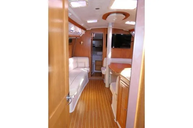 Slide: The Image of Interior of 2008 Catalina 400 MK II yacht with wood flooring and white seating. - 35
