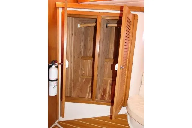 Slide: The Image of Wooden closet interior on 2008 Catalina 400 MK II yacht with fire extinguisher nearby. - 37