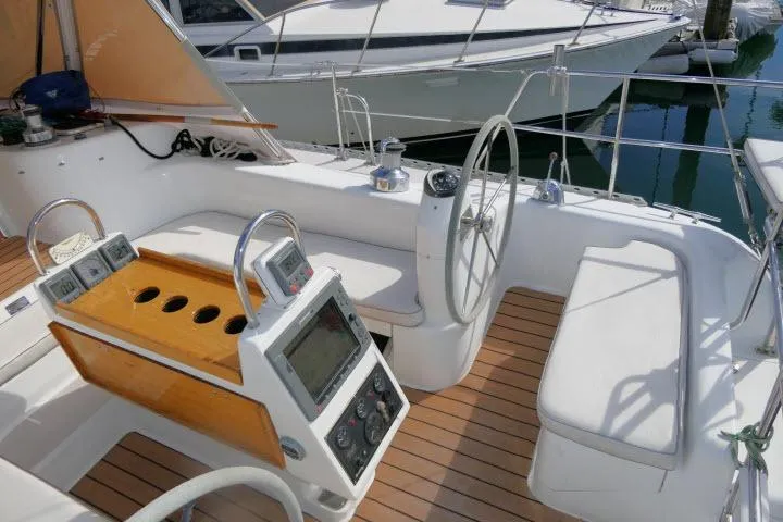 Slide: The Image of Cockpit of 2008 Catalina 400 MK II sailboat with steering wheel and navigation instruments. - 43