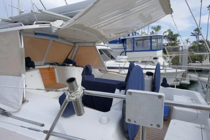 Slide: The Image of 2008 Catalina 400 MK II sailboat with covered seating area in a marina. - 52