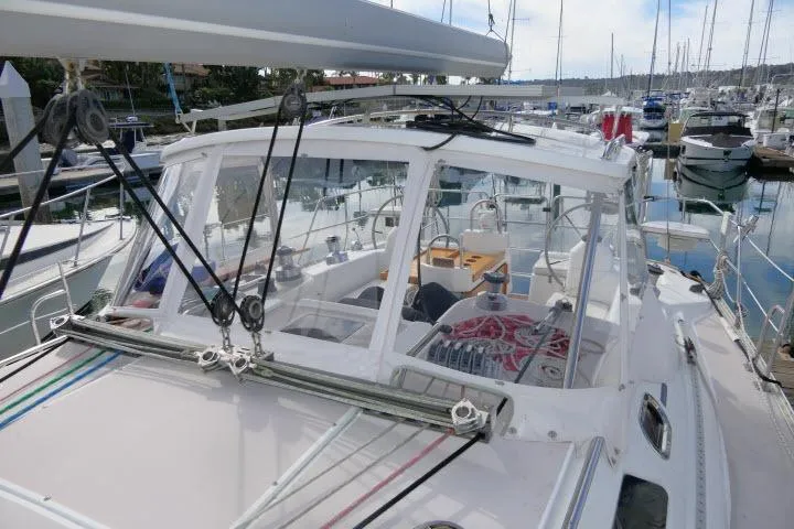 Slide: The Image of 2008 Catalina 400 MK II sailboat docked in a marina, showcasing cockpit and rigging. - 58