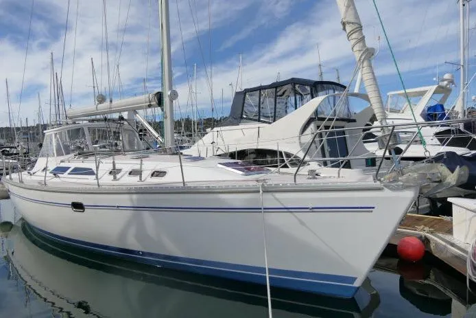 Slide: The Image of 2008 Catalina 400 MK II sailboat docked in marina, clear sky background. - 69