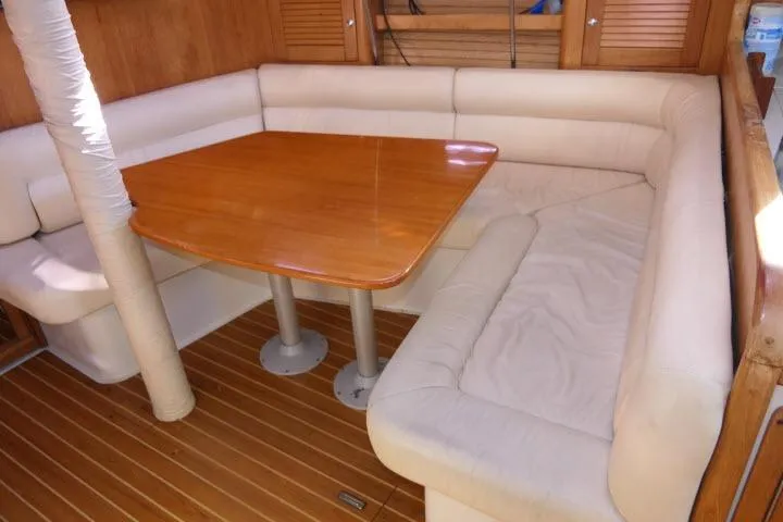 Slide: The Image of Cozy dining area in 2008 Catalina 400 MK II yacht with wooden table and cushioned seating. - 7