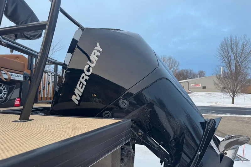 Slide: The Image of 2026 Princecraft Vogue 25 with Mercury outboard motor, parked in snowy setting. - 8