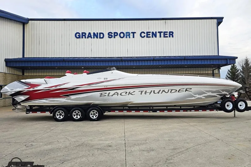 Slide: The Image of 2004 Black Thunder 460 boat at Grand Sport Center, featuring sleek design and vibrant graphics. - 1