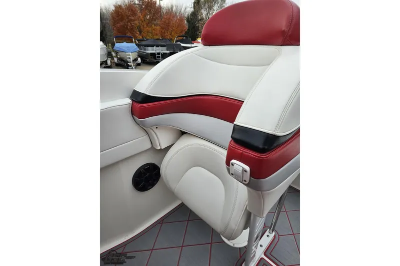 Slide: The Image of Red and white boat seat in a 2004 Black Thunder 460, with autumn trees in background. - 102