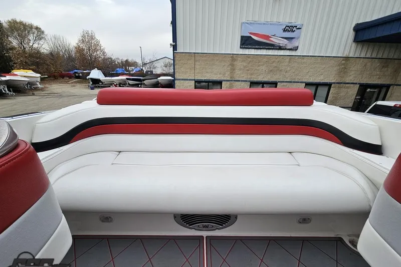 Slide: The Image of 2004 Black Thunder 460 boat interior with red and white seating, docked outdoors. - 103