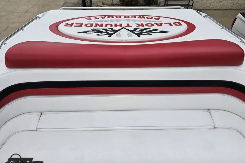 Slide: The Image of 2004 Black Thunder 460 boat upholstery with red and black accents, featuring logo design. - 104