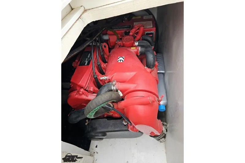 Slide: The Image of Red engine inside a 2004 Black Thunder 460 boat compartment. - 108