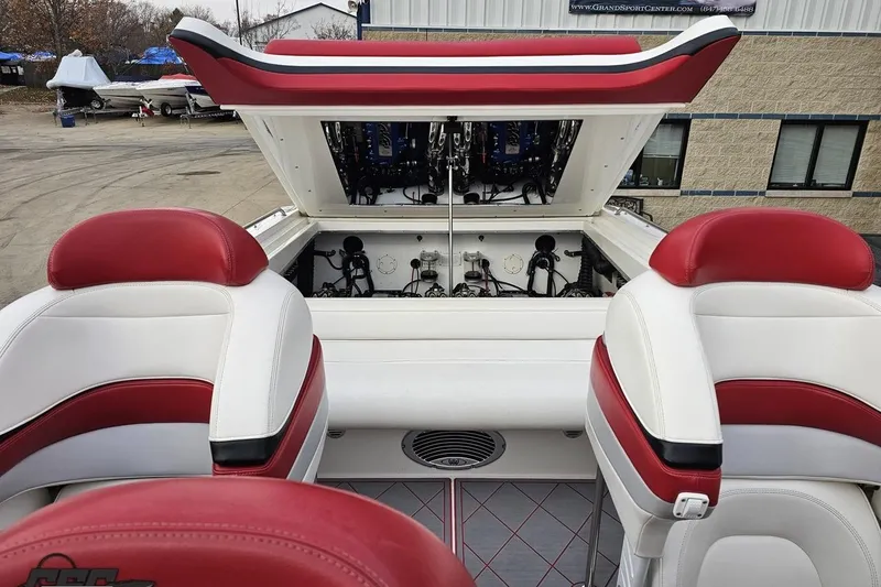 Slide: The Image of 2004 Black Thunder 460 boat interior with red and white seating and open engine compartment. - 111