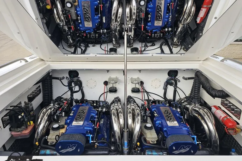 Slide: The Image of Engine compartment of a 2004 Black Thunder 460 boat with dual high-performance engines. - 113