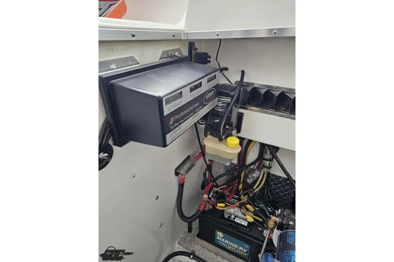 Slide: The Image of Electrical system inside a 2004 Black Thunder 460 boat, featuring a battery and wiring. - 121