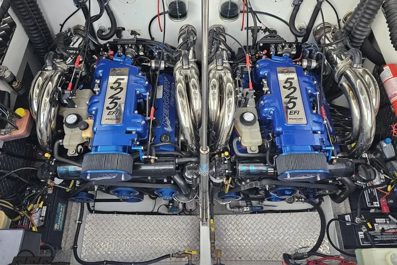 Slide: The Image of Twin Mercury 525 EFI engines in a 2004 Black Thunder 460 boat. - 123