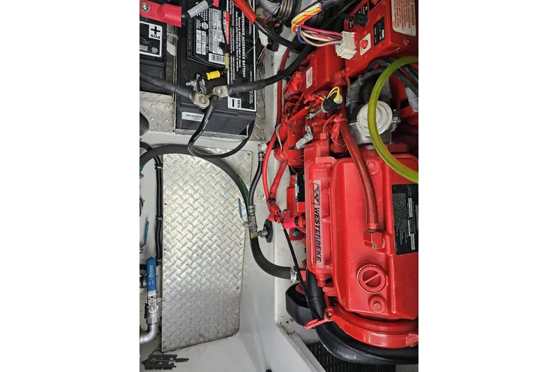 Slide: The Image of Engine compartment of a 2004 Black Thunder 460 with Westerbeke generator and battery. - 124