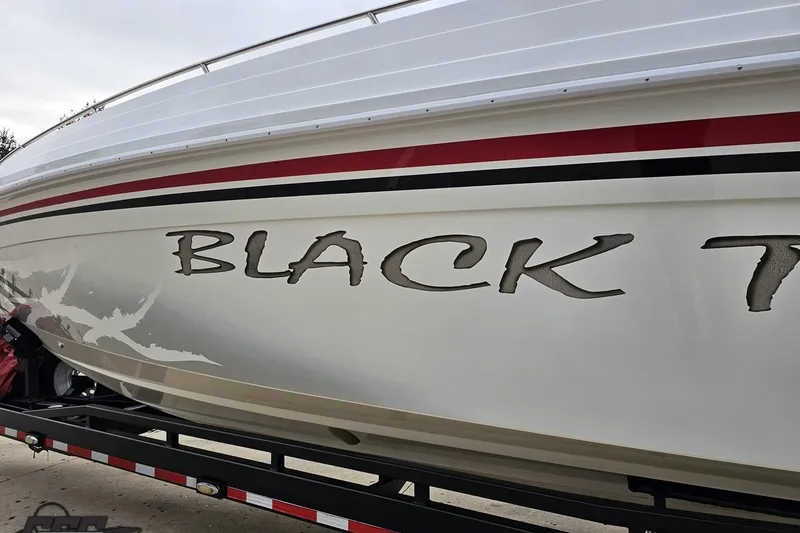 Slide: The Image of 2004 Black Thunder 460 boat with bold lettering on the side, displayed on a trailer. - 17