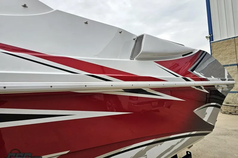 Slide: The Image of 2004 Black Thunder 460 boat with red, white, and black graphic design. - 22