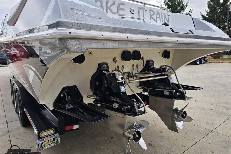 Slide: The Image of 2004 Black Thunder 460 boat rear view with dual propellers and trailer. - 26