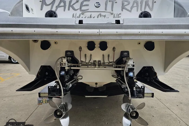 Slide: The Image of Rear view of a 2004 Black Thunder 460 boat with dual propellers. - 27