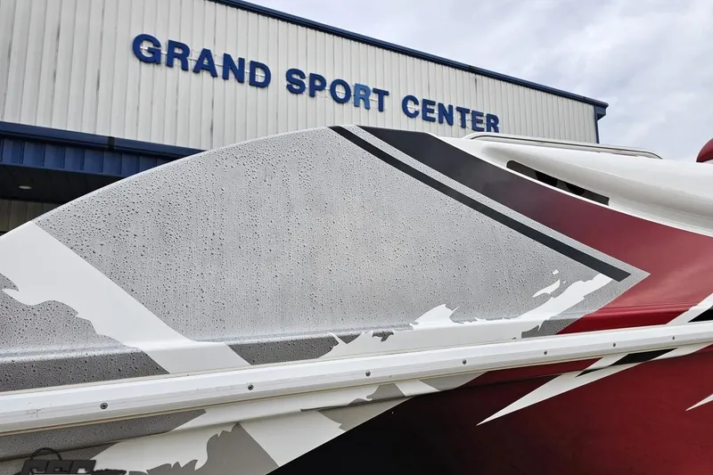 Slide: The Image of 2004 Black Thunder 460 boat at Grand Sport Center, showcasing sleek design and graphics. - 32