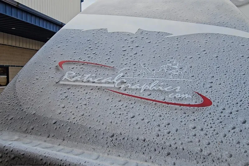 Slide: The Image of Close-up of a 2004 Black Thunder 460 boat with water droplets and custom graphics. - 34