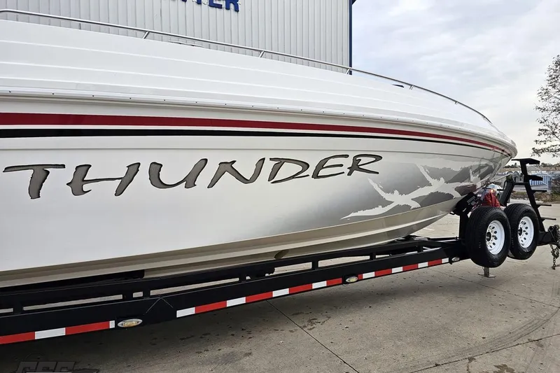 Slide: The Image of 2004 Black Thunder 460 boat on trailer, featuring bold "Thunder" graphics. - 4