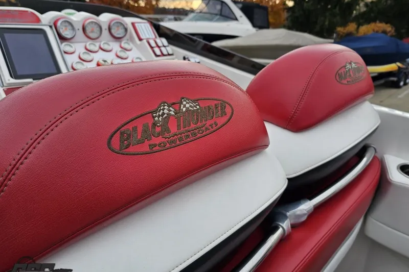 Slide: The Image of Red and white interior of a 2004 Black Thunder 460 powerboat with branded seats. - 50